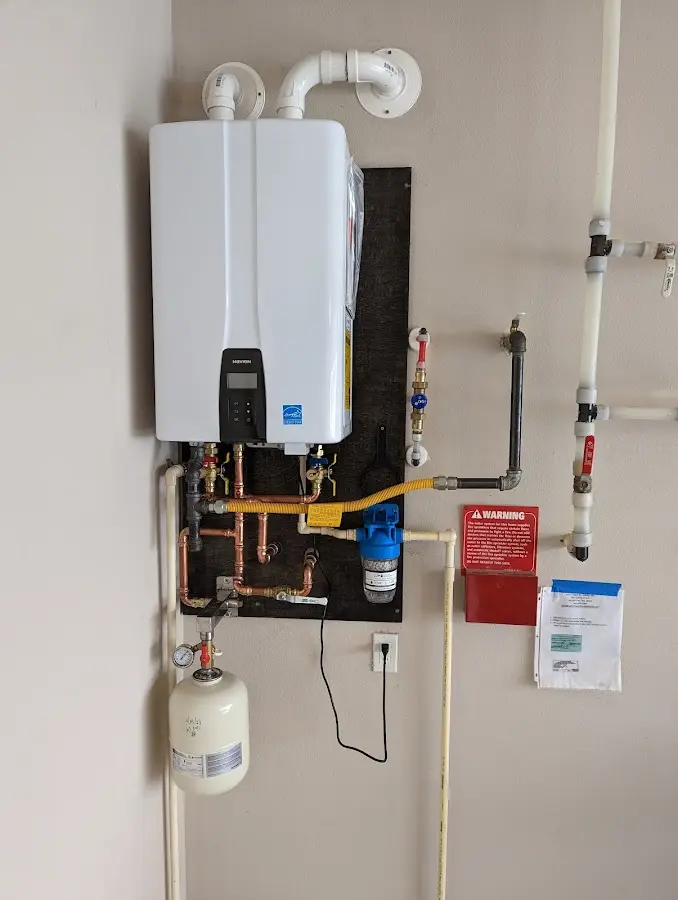 Professional plumber installing copper piping in a Northbrook home